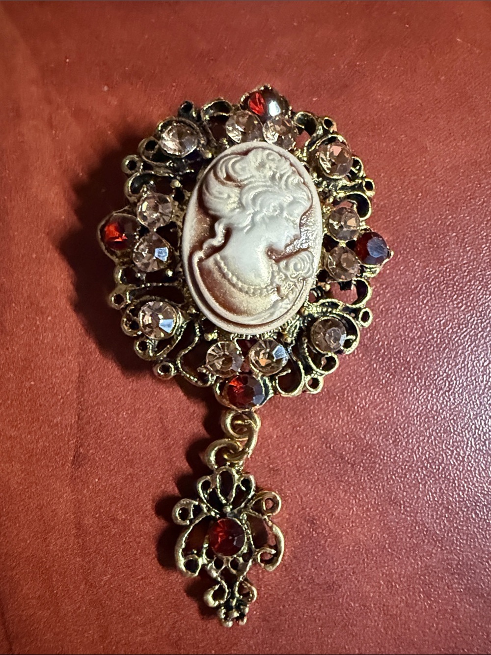 Vintage-Inspired Gold Cameo Brooch with Red and Clear Crystals